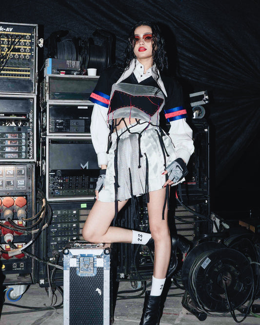 Model backstage at the BUDXNBAHOUSE fashion show wearing White Cropped Shirt