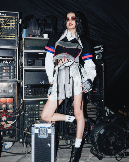 Model backstage at the BUDXNBAHOUSE fashion show wearing White Cropped Shirt