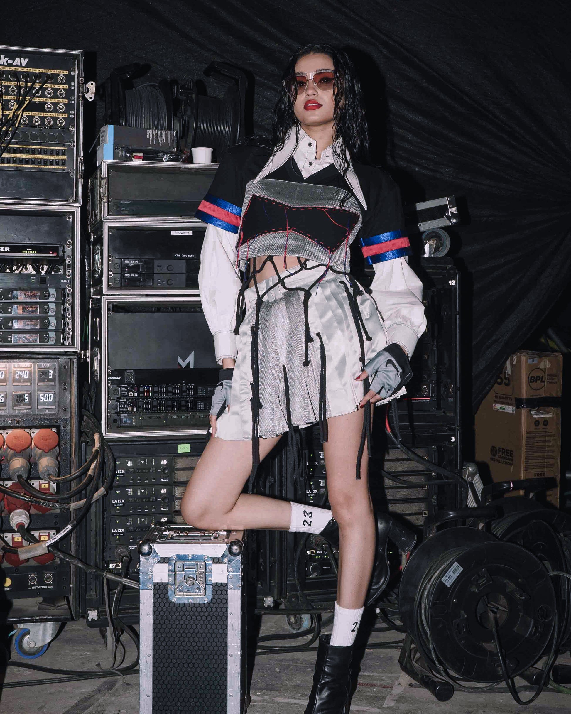 Model backstage at the BUDXNBAHOUSE fashion show wearing Black Silver Crop Top