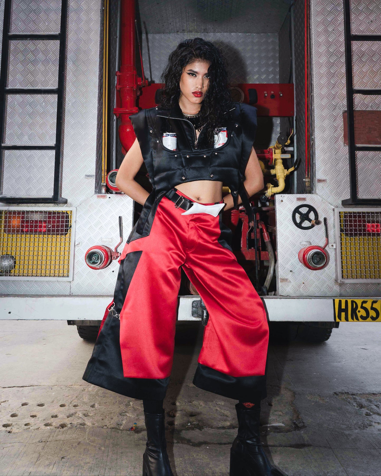 Model backstage at the BUDXNBAHOUSE fashion show wearing Apex Red Black Satin Jorts