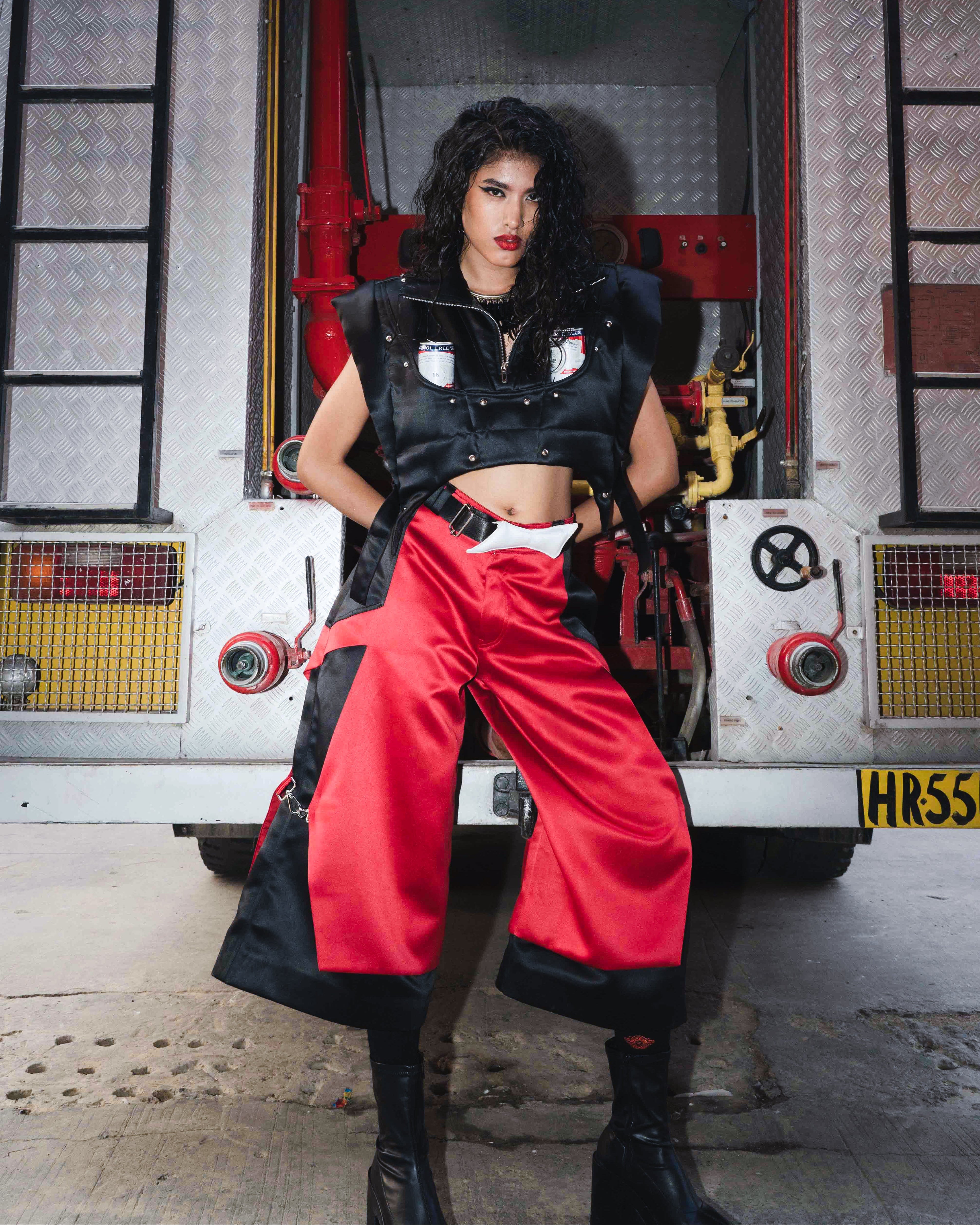 Model backstage at the BUDXNBAHOUSE fashion show wearing Apex Red Black Satin Jorts