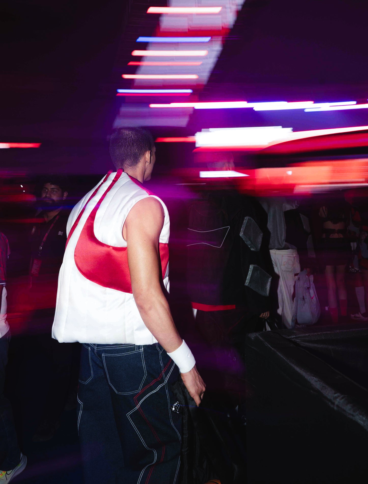 Model backstage at the BUDXNBAHOUSE fashion show wearing Rogue White Puffer Vest