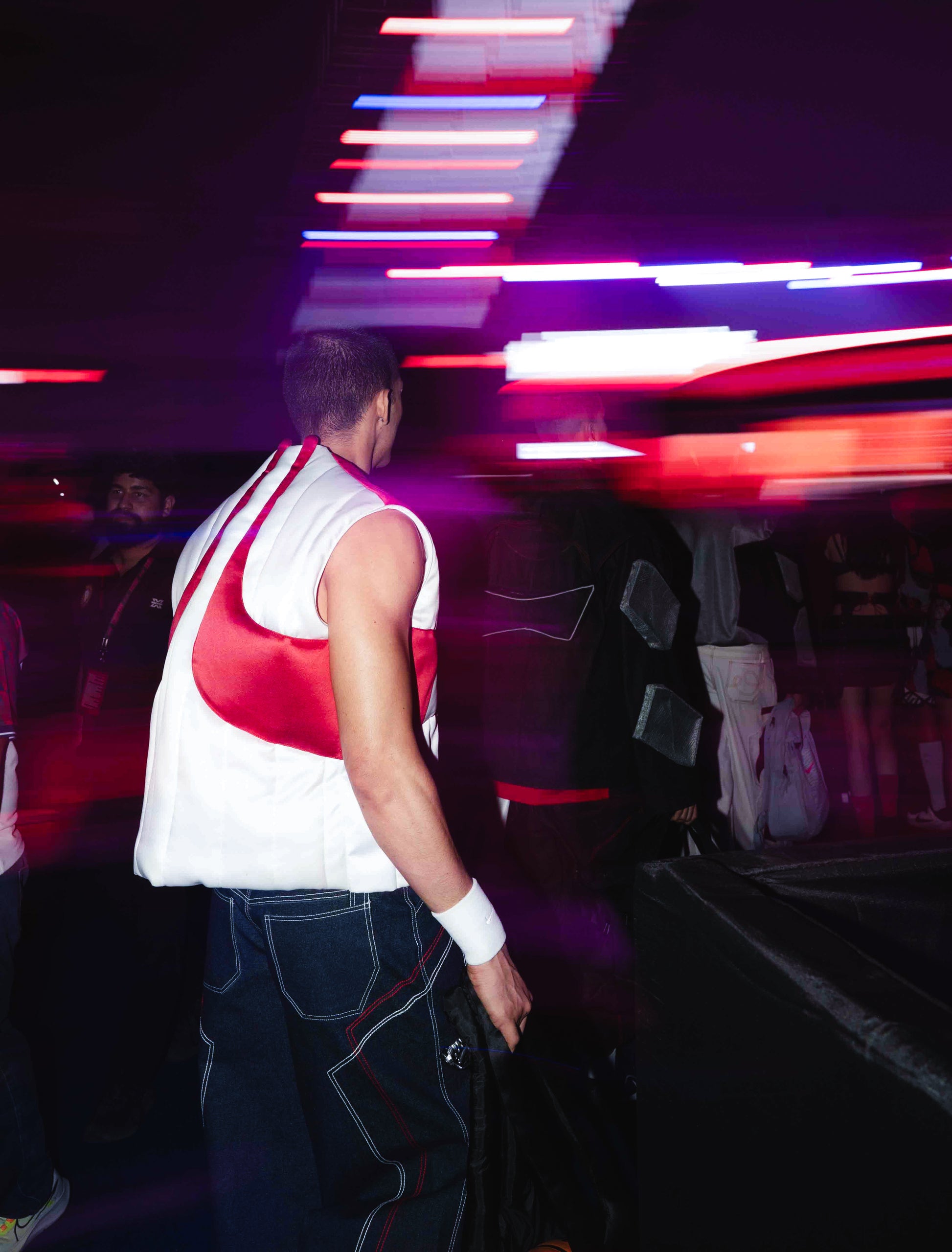 Model backstage at the BUDXNBAHOUSE fashion show wearing Rogue White Puffer Vest
