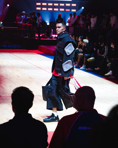 Model backstage at the BUDXNBAHOUSE fashion show wearing Knee Pad Black Denim Jorts