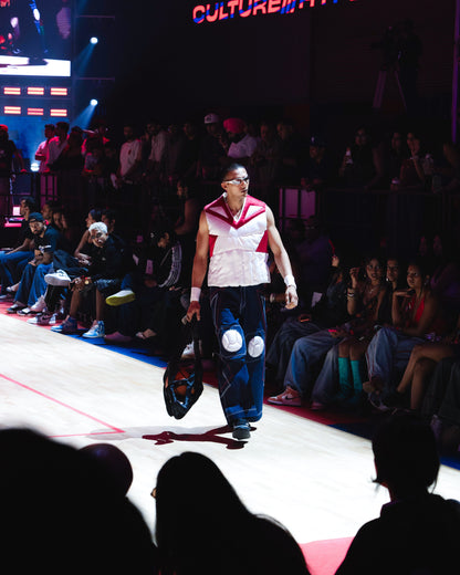 Model walking the ramp at the BUDXNBAHOUSE fashion show wearing Sleeveless Rogue White Puffer Vest