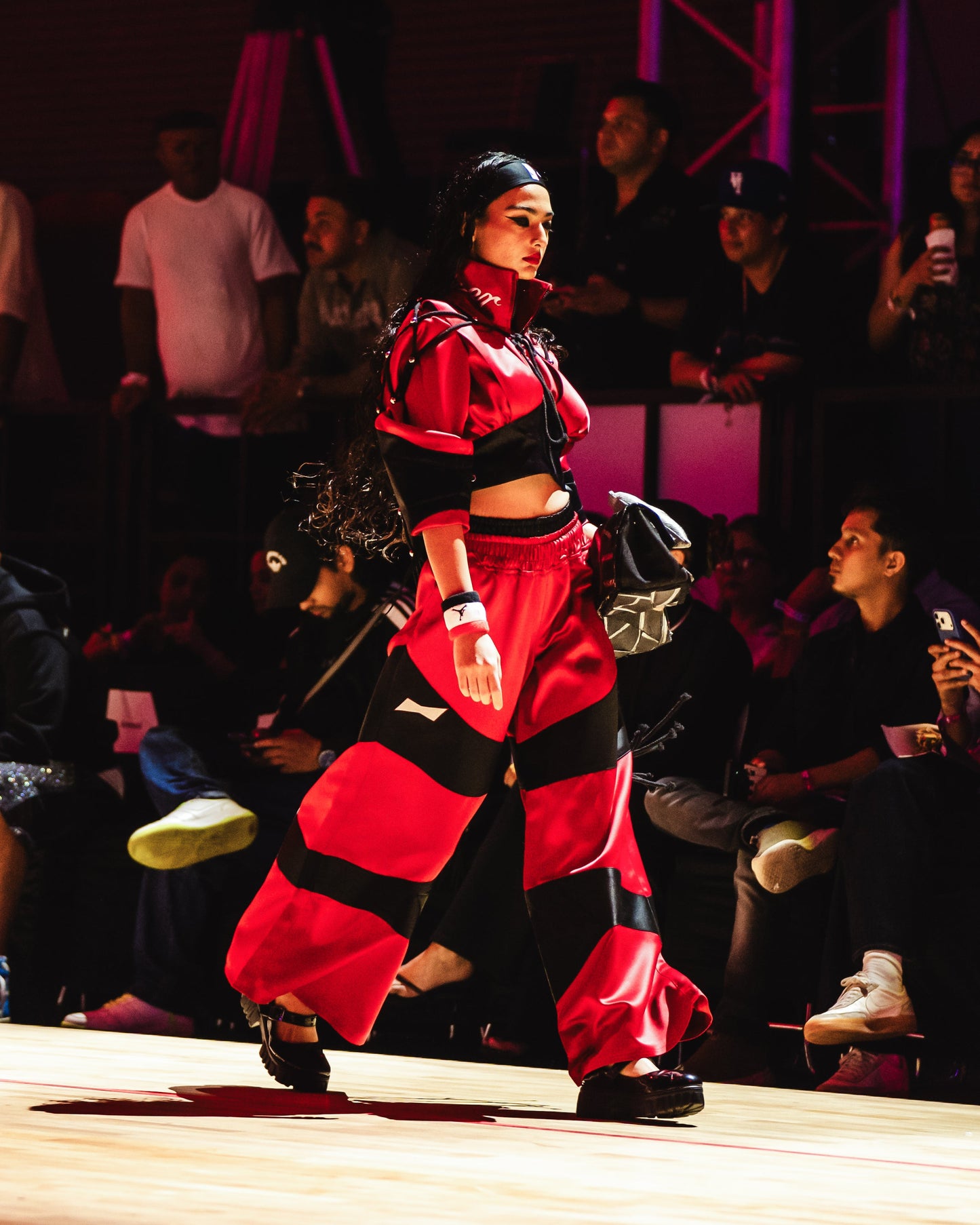 Model walking on a runway at the BUDXNBAHOUSE fashion show wearing Satine Cropped Sweatshirt