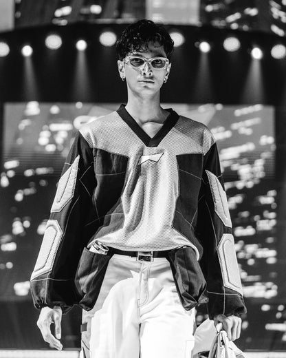 Model walking on a runway at a BUDXNBAHOUSE fashion show wearing Silver Black Patchwork T-shirt.