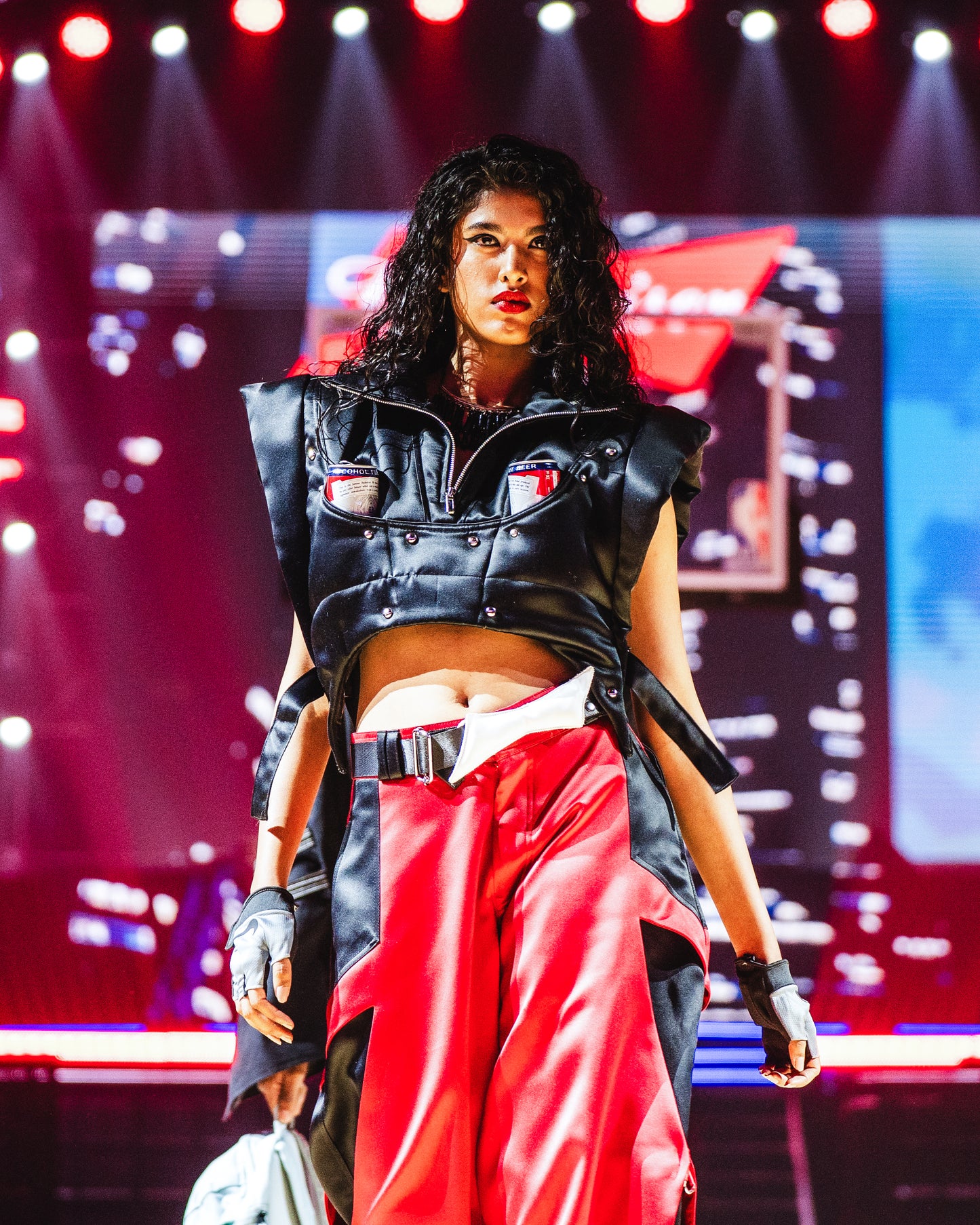 Model walking the runway at the BUDXNBAHOUSE fashion show wearing Black Puffer Vest