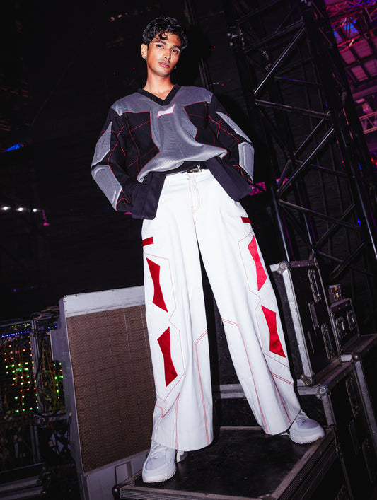 Model backstage at the BUDXNBAHOUSE fashion show wearing White Jeans with Red Patchwork detailing.