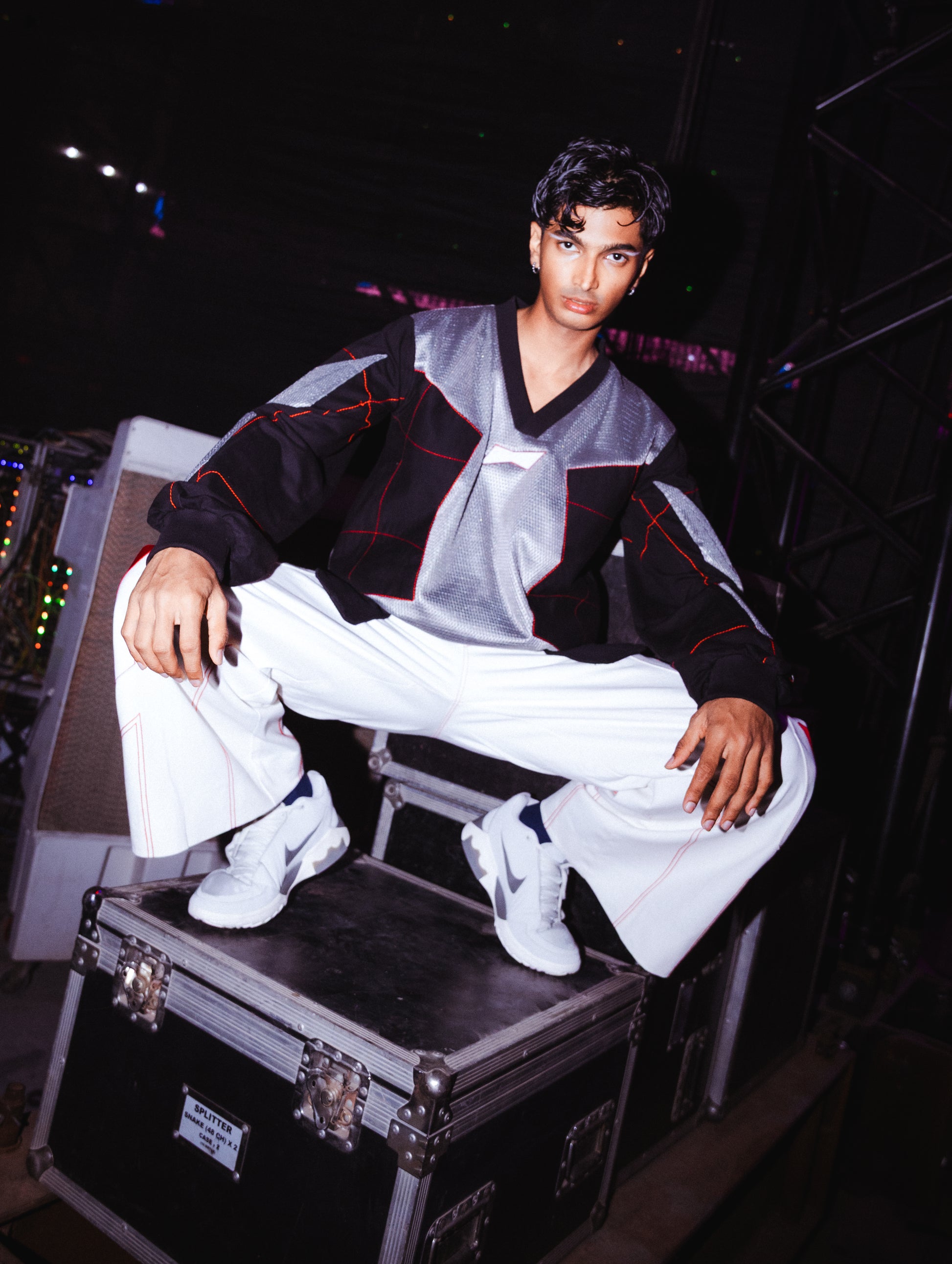 Model backstage at the BUDXNBAHOUSE fashion show wearing Silver Black patchwork T-shirt.
