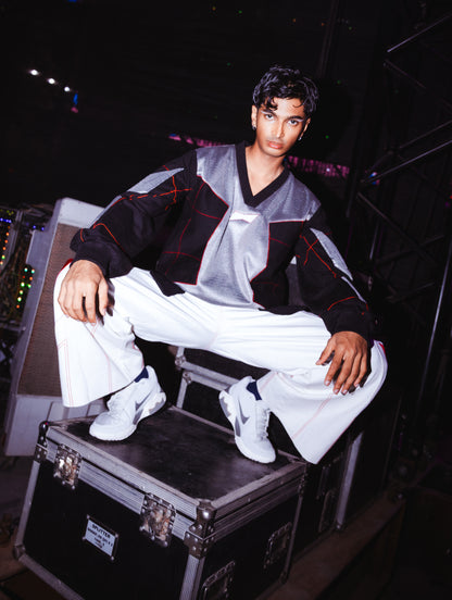 Model backstage at the BUDXNBAHOUSE fashion show wearing Silver Black patchwork T-shirt.