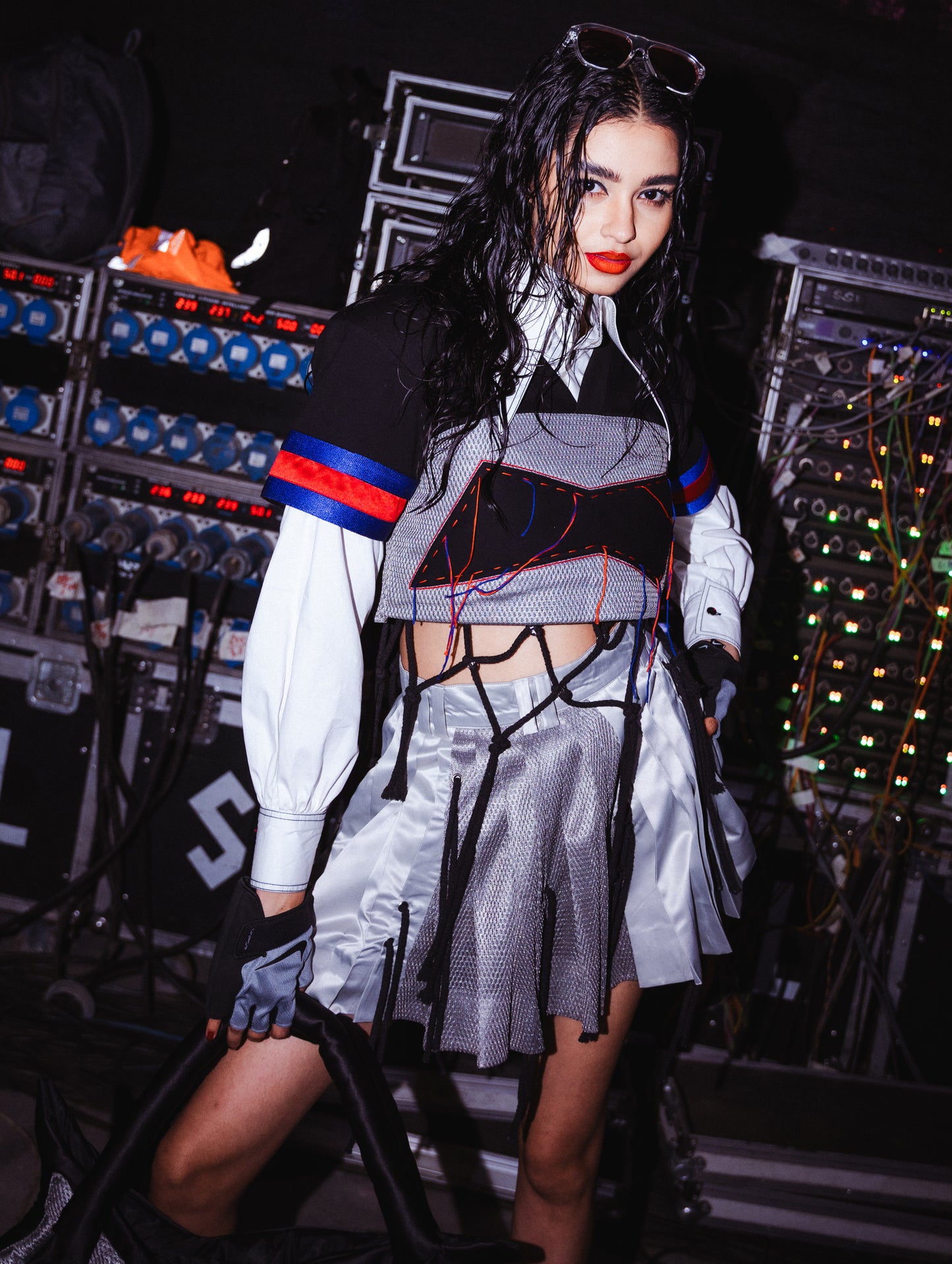 Model backstage at the BUDXNBAHOUSE fashion show wearing Silver Mini SKirt with rivet and ropes detailing.