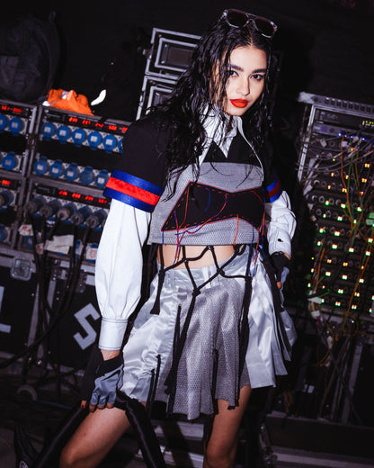 Model backstage at the BUDXNBAHOUSE fashion show wearing Black Silver Crop Top