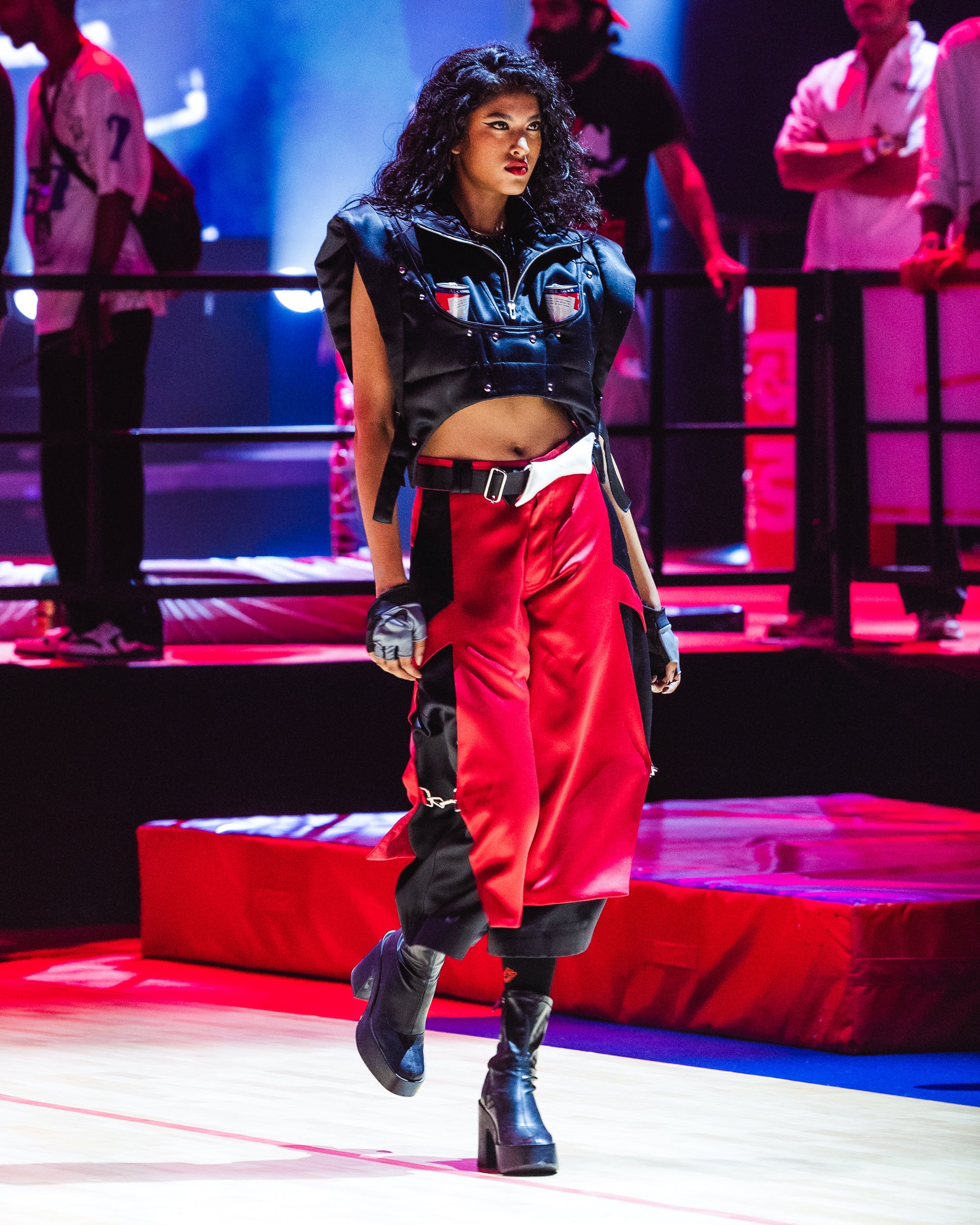 Model walking the ramp at the BUDXNBAHOUSE fashion show wearing Apex Black Satin Puffer Jacket Vest